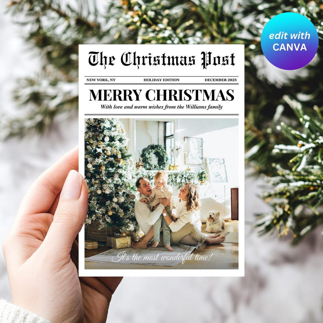 Hand holding a black-and-white newspaper Christmas card featuring a full-width family photo and Merry Christmas headline.