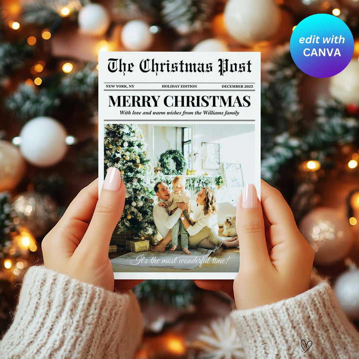 Full-photo newspaper Christmas card held in two hands in front of warm Christmas tree lights.